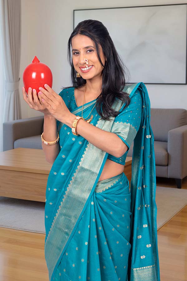 Indian woman holding piggy bank for personal finance savings
