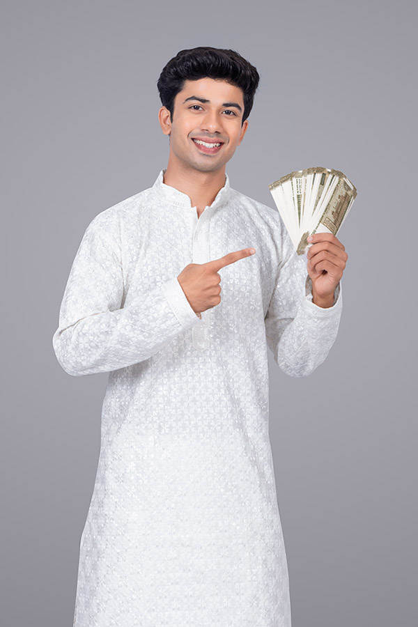 Young Indian man showing cash currency notes on grey background