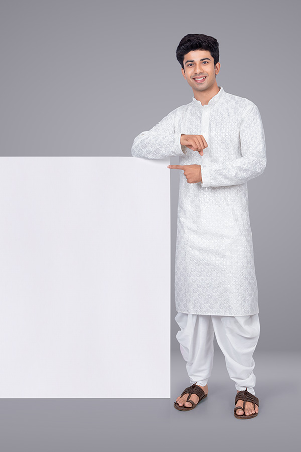 Indian man standing beside blank display board for advertising concept
