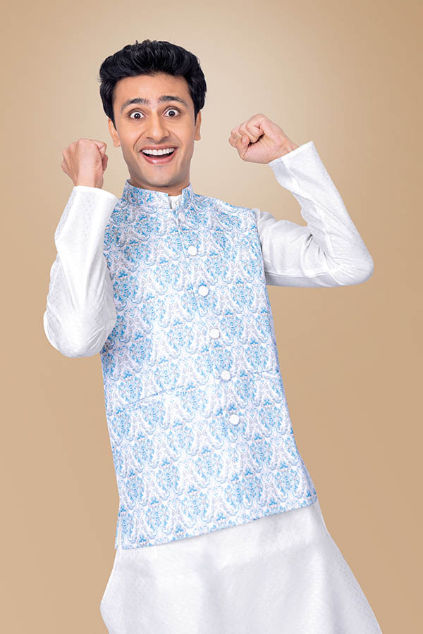 Excited Indian man celebrating festive success in traditional outfit