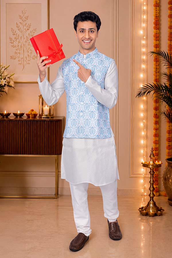 Smiling Indian man holding festive gift box during Diwali celebration