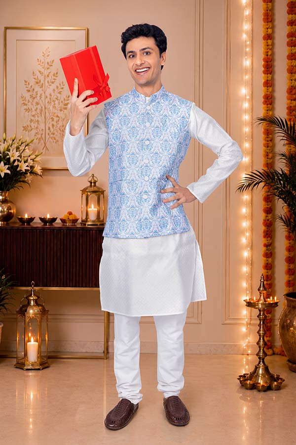 Smiling Indian man showcasing festive gift hamper during Diwali