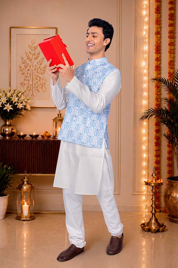 Happy Indian man admiring festive gift box at home