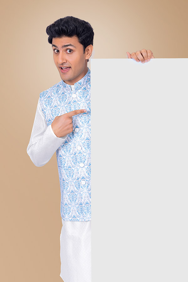 Curious Indian man pointing towards blank signboard for festive offers