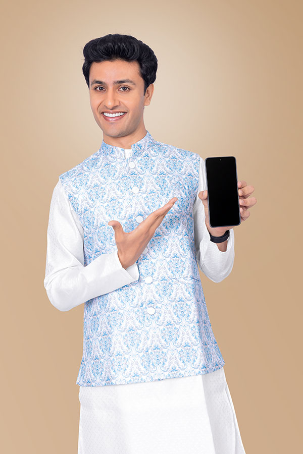 Smiling Indian man presenting smartphone for festive digital marketing