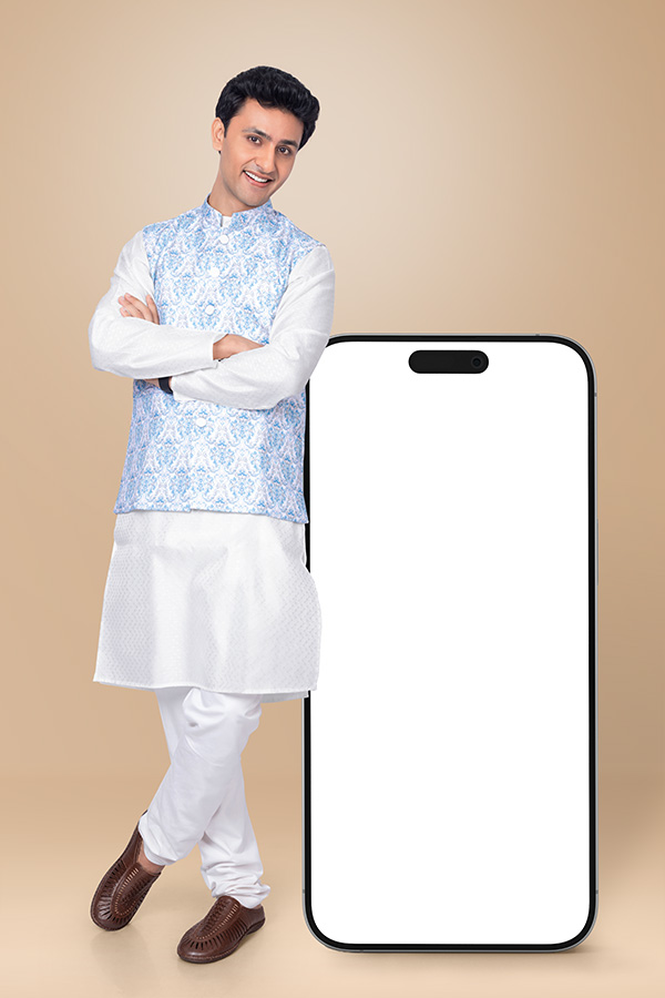 Smiling Indian man standing beside smartphone display for festive digital campaign