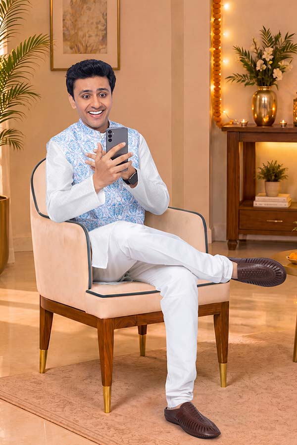 Young Indian man smiling during video call on smartphone at home