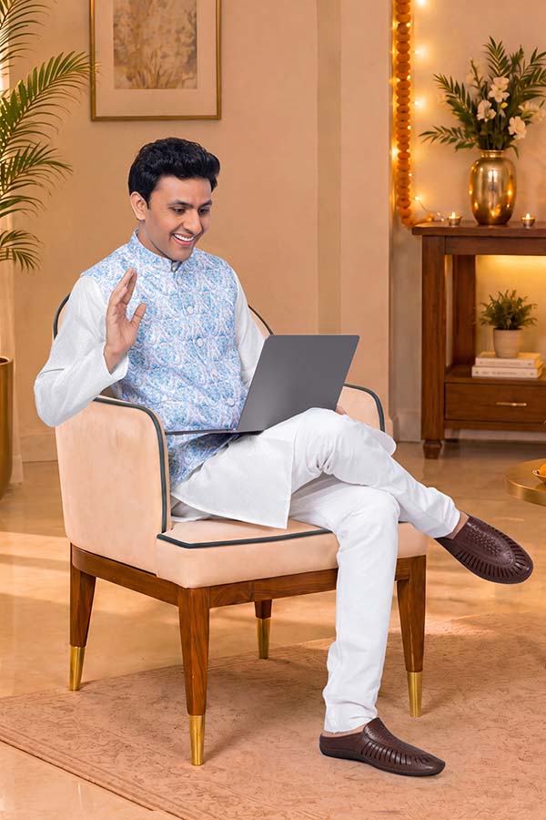 Young Indian man on video call using laptop during Diwali