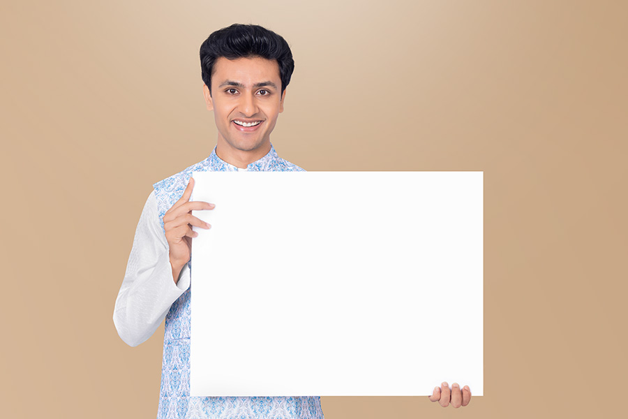 Indian man holding blank placard for festive advertising campaign