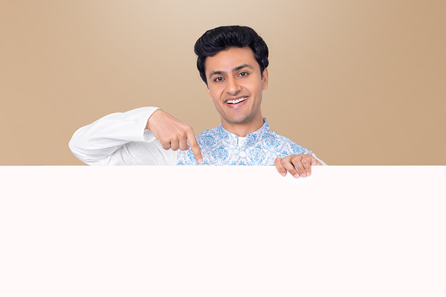 Indian man pointing towards blank promotional banner during festive celebration
