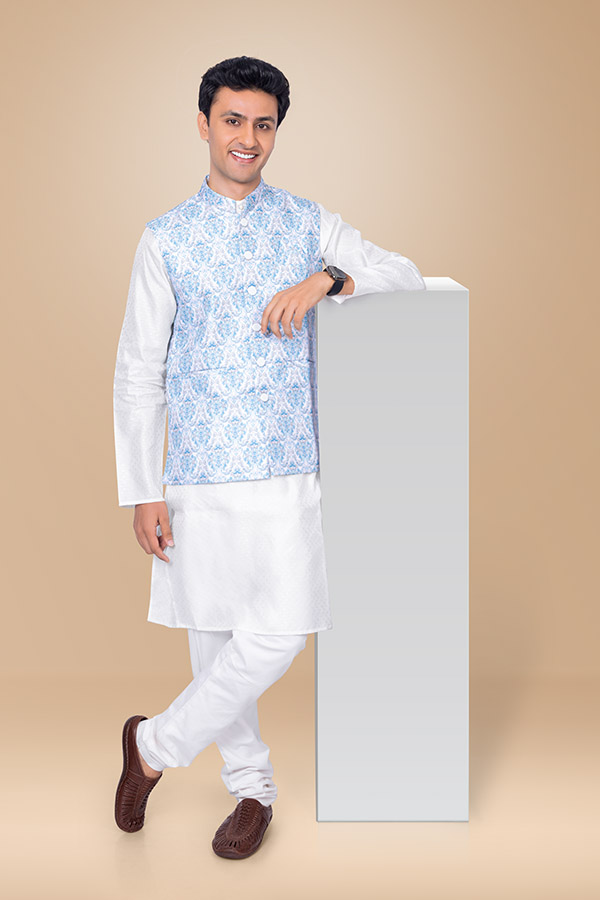 Confident Indian man leaning on display podium in festive attire