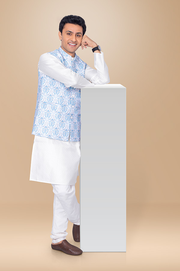 Indian man posing beside display pedestal for festive product promotion