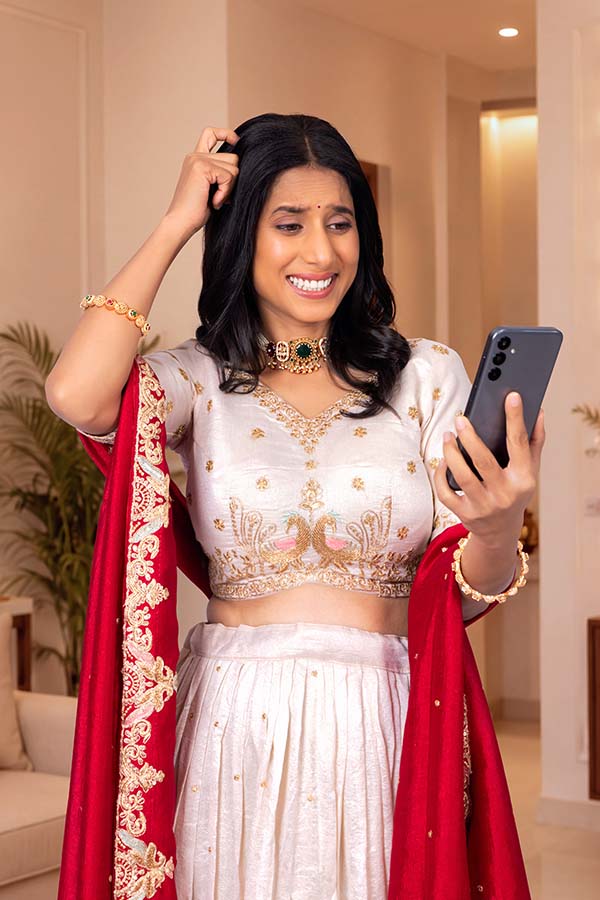 Indian woman looking confused while using smartphone during Diwali