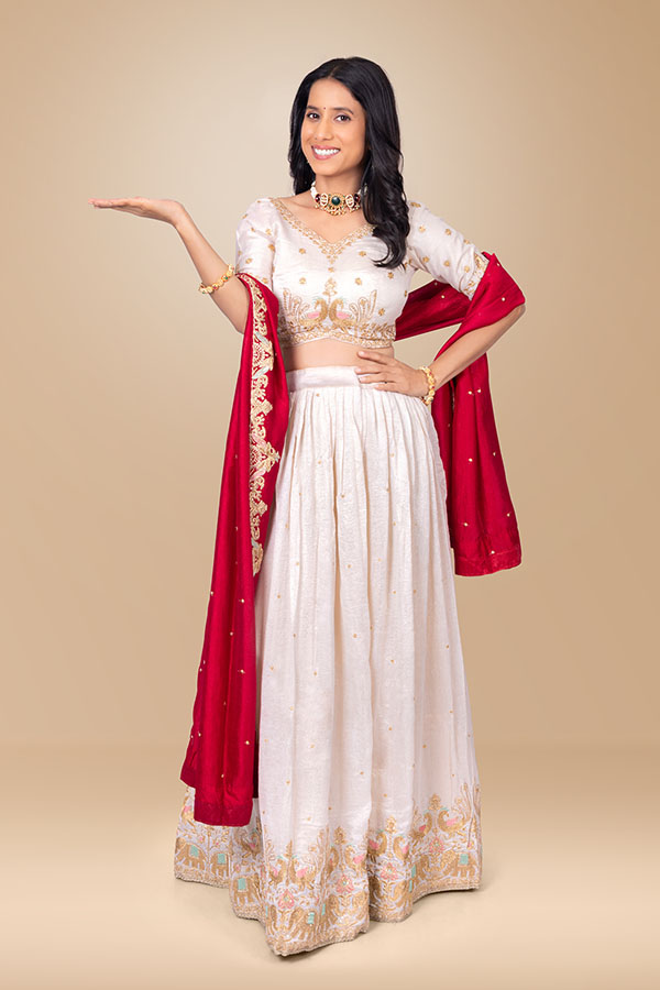 Indian woman pointing towards presentation space with smiling expression