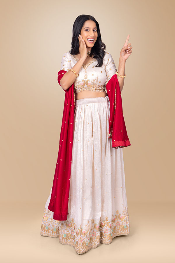 Indian woman pointing upward with surprised festive expression