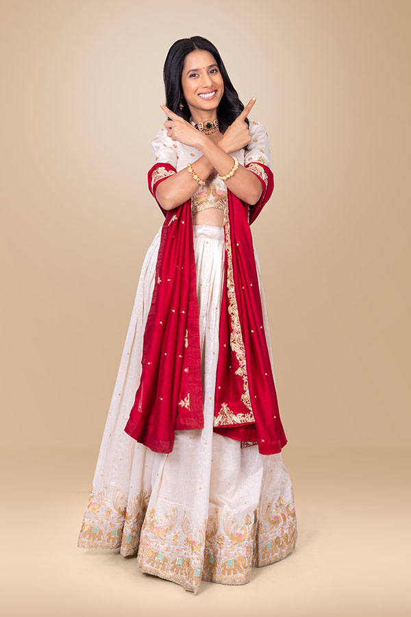 Indian woman crossing hands while pointing in opposite directions