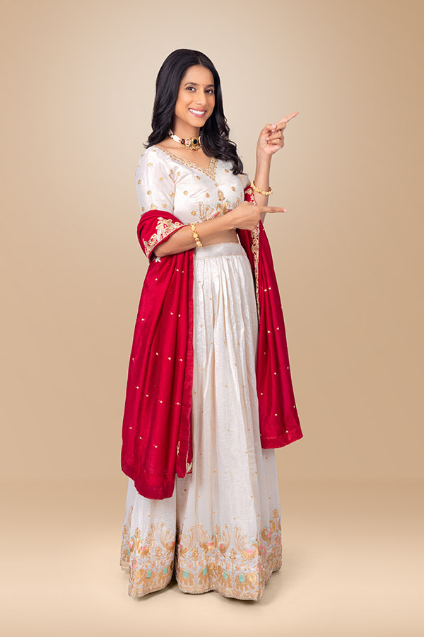 Indian woman pointing in two directions with festive smile