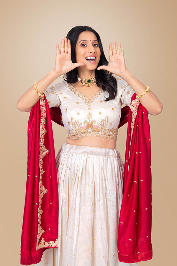 Indian woman making announcement gesture during festive celebration