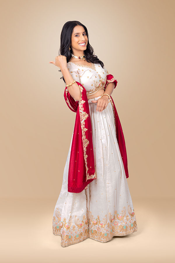 Indian woman pointing behind with thumb in festive ethnic wear