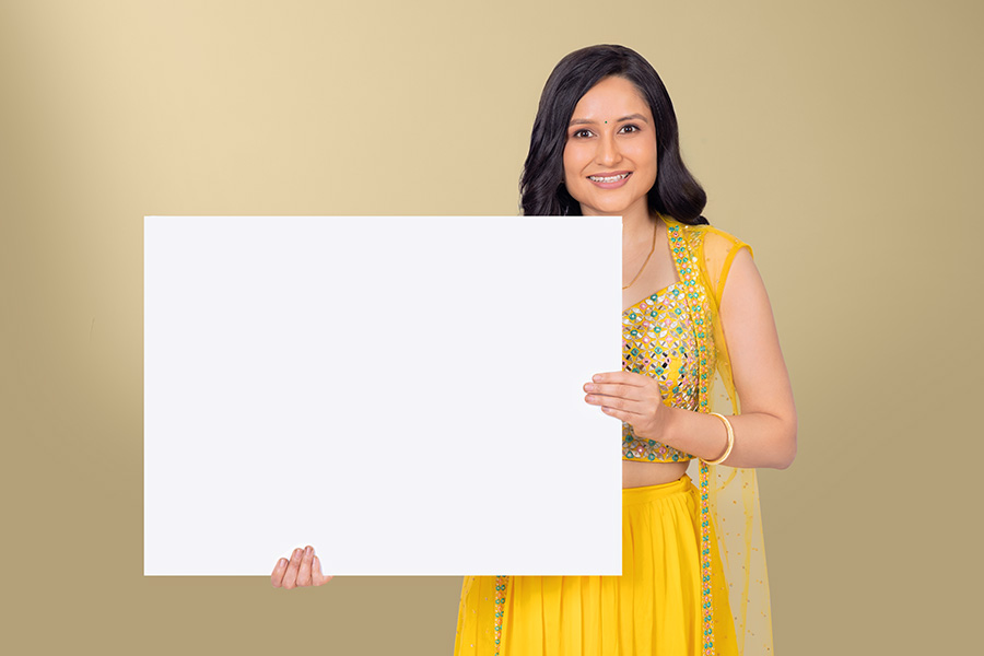 Indian woman holding blank white signboard for festive advertising campaign