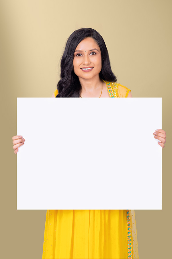Indian woman holding large blank poster for festive promotional design