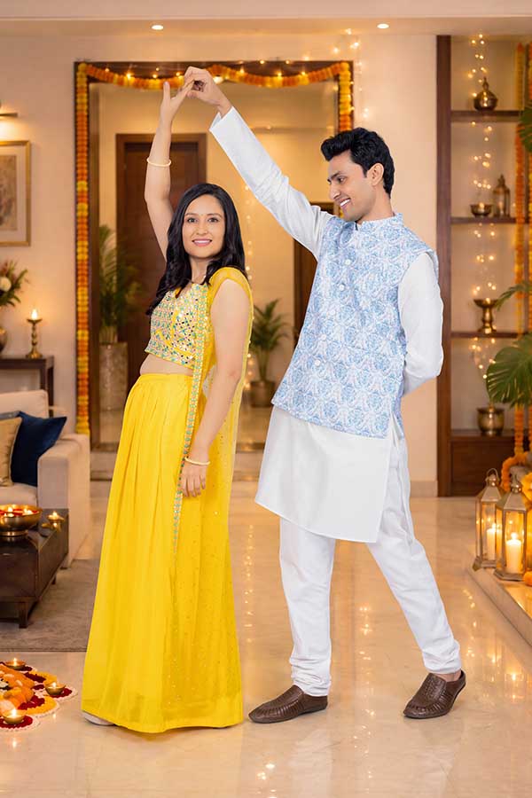 Indian couple dancing together during Diwali celebration at home