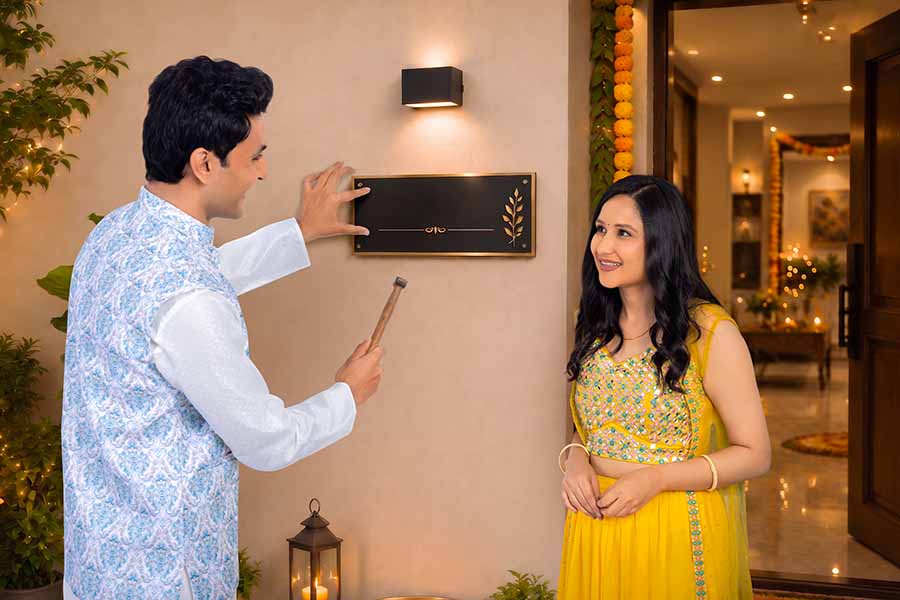 Indian couple decorating home together for Diwali celebration
