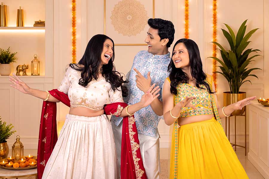 Indian friends dancing together during Diwali celebration at home
