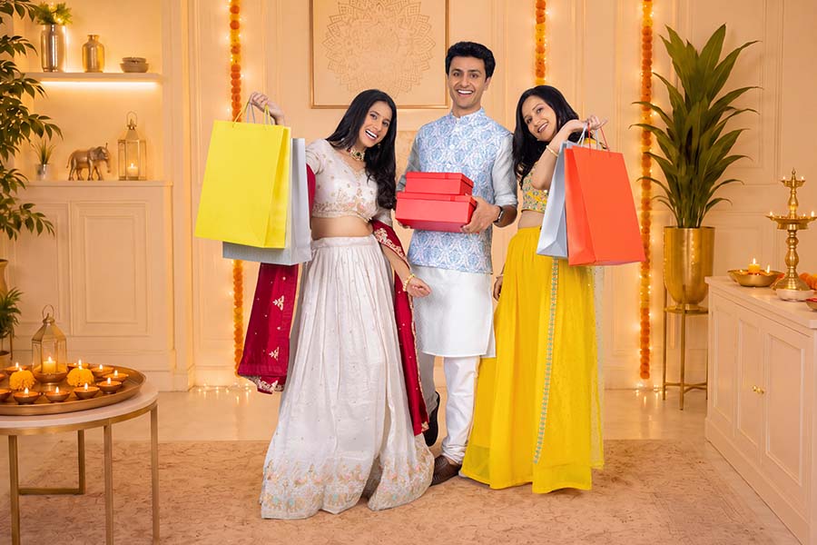 Young Indian friends celebrating Diwali with gifts and shopping bags