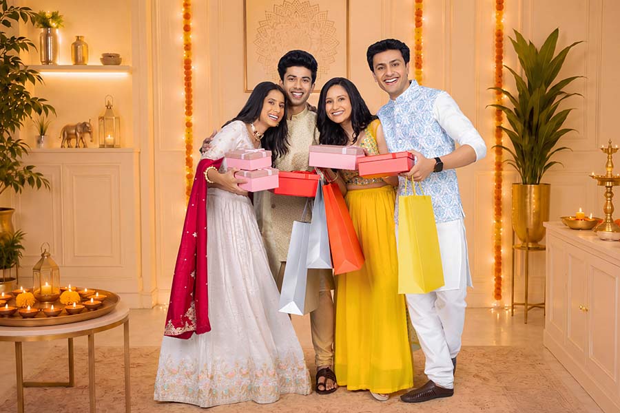 Group of young Indian friends celebrating Diwali with gifts