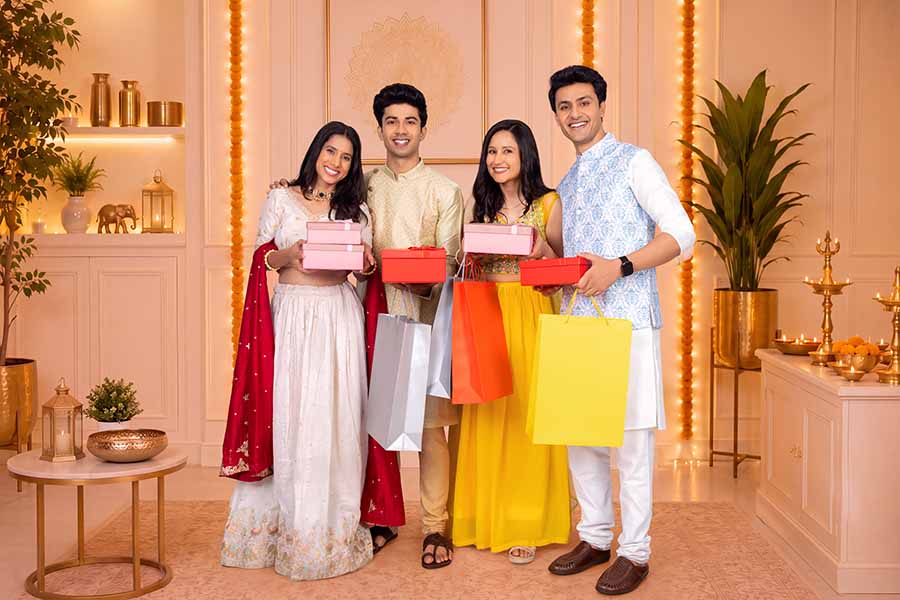 Group of Indian adults exchanging gifts during Diwali celebration
