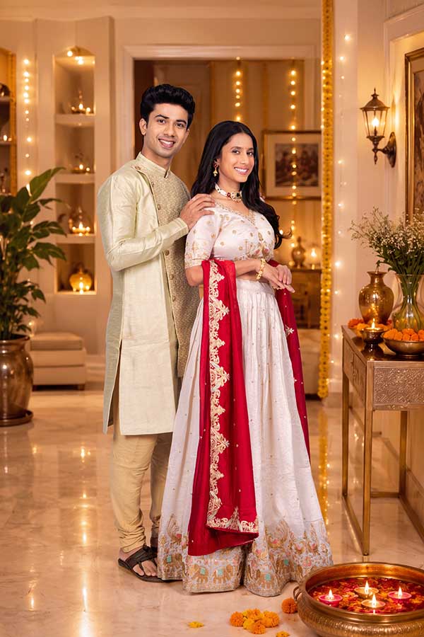 Elegant Indian couple posing together during Diwali celebration at home