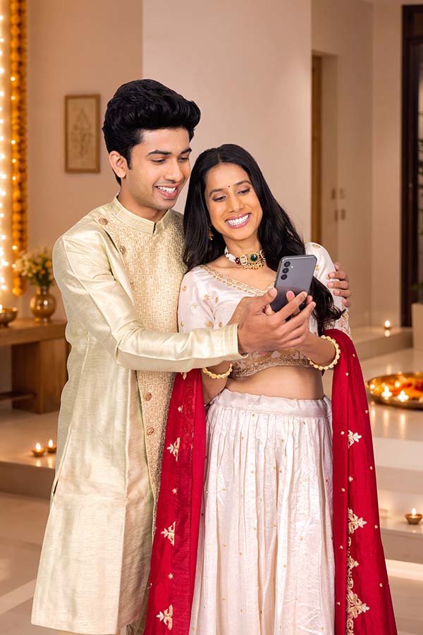 Indian couple checking smartphone together during festive season