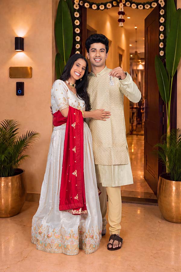 Happy Indian couple celebrating festival after buying a new home