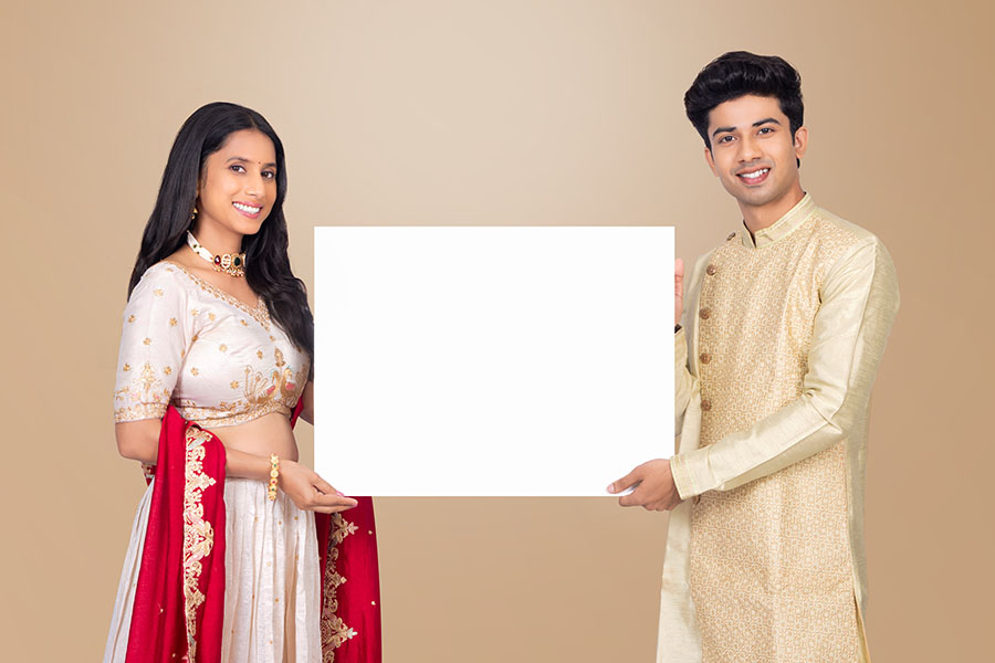 Indian festive couple holding blank signboard for advertising