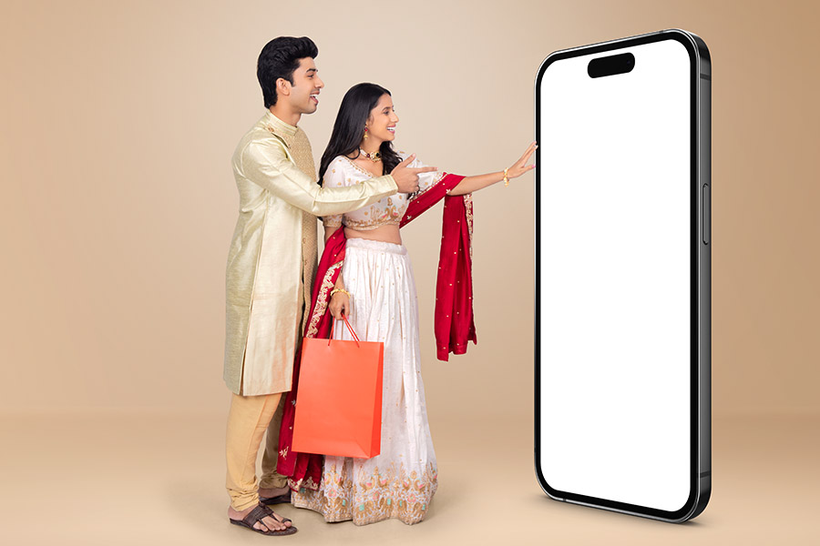 Indian festive couple interacting with blank smartphone mockup
