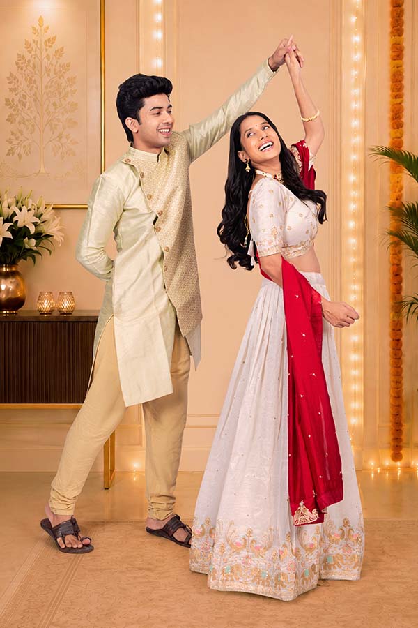 Happy Indian couple dancing together during Diwali celebration