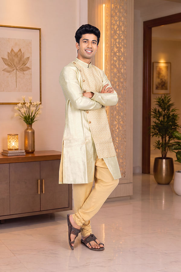 Confident young Indian man posing in traditional festive attire