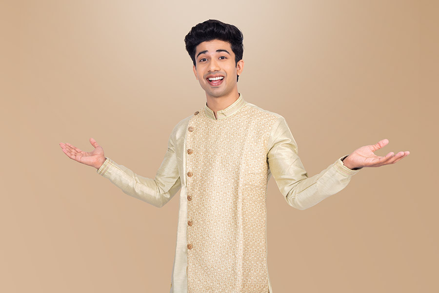 Smiling Indian man presenting copy space with open hands