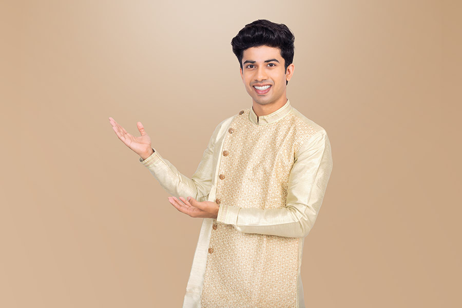 Indian man pointing towards copy space in festive attire