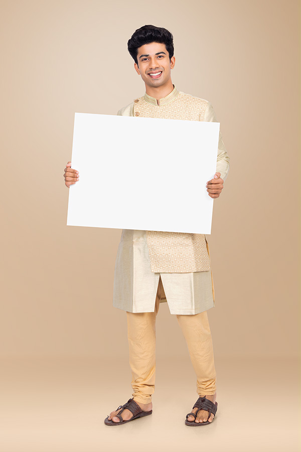 Indian man presenting blank white board for festive advertising