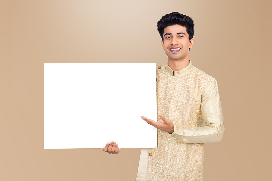 Indian man presenting blank signboard with copy space