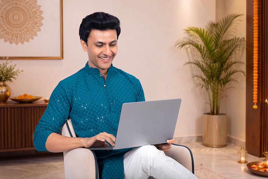 Young Indian entrepreneur working remotely during festive season