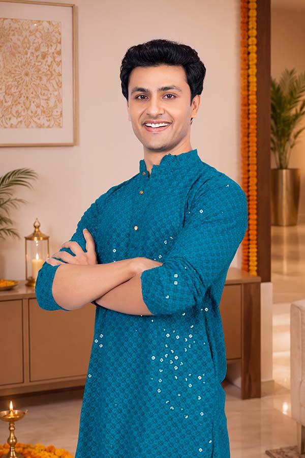 Confident Indian man posing in festive blue ethnic kurta