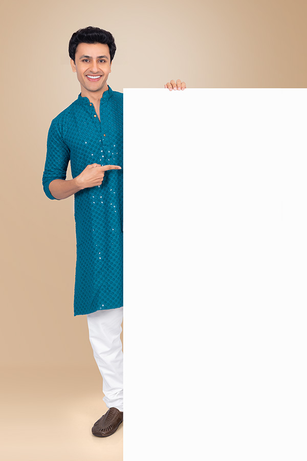 Indian man presenting large blank signboard in festive blue kurta