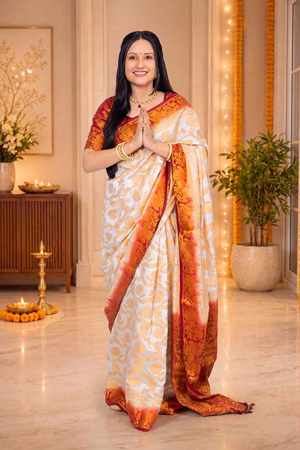 Indian woman greeting with namaste in traditional festive saree