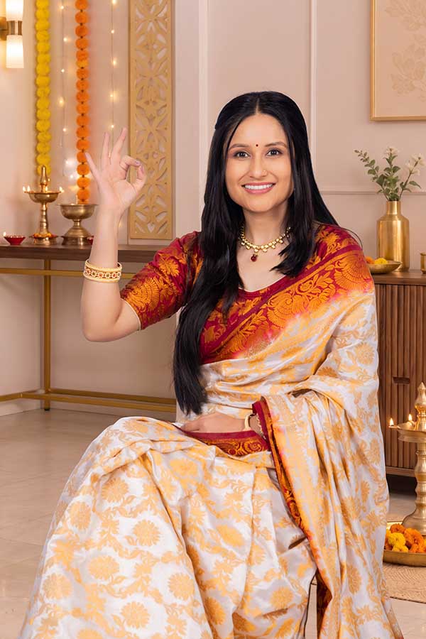 Indian woman showing approval with OK gesture during Diwali celebration