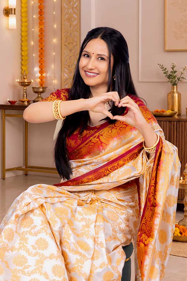 Indian woman making heart gesture during Diwali celebration