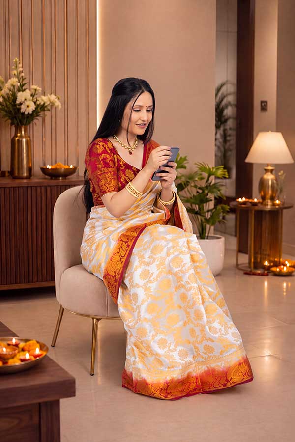 Indian woman using smartphone during Diwali celebration at home