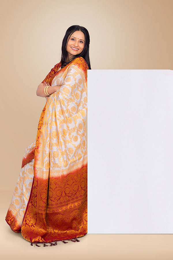Indian woman in traditional saree posing beside blank copy space